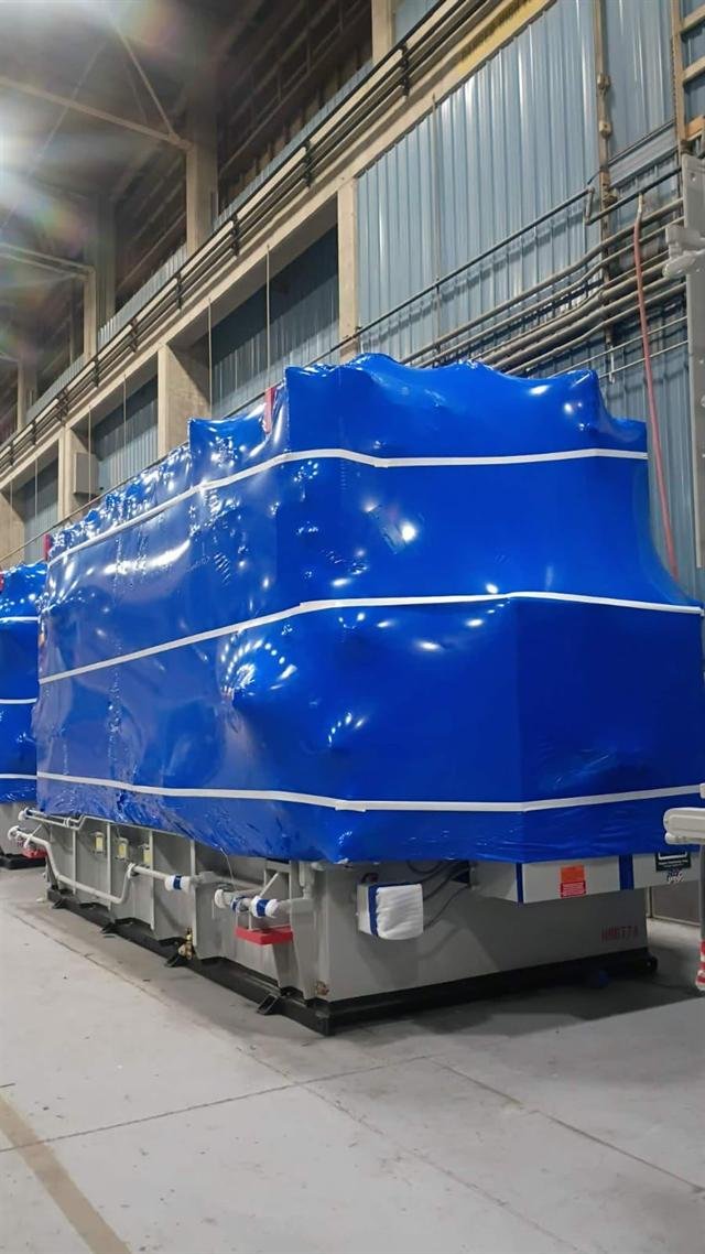 Wrapped transformers staged in a row awaiting shipment